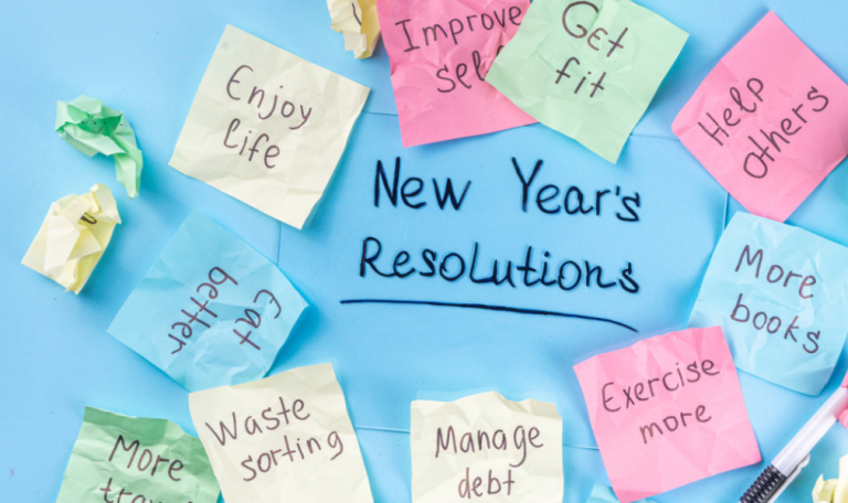 Colorful sticky notes with various New Year's resolutions written on them, including 'Get fit' and 'Save money,' arranged on blue background.
